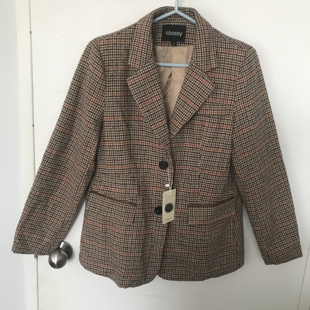 Ladies medium size checkered jacket with leather like patch on back of sleeve.